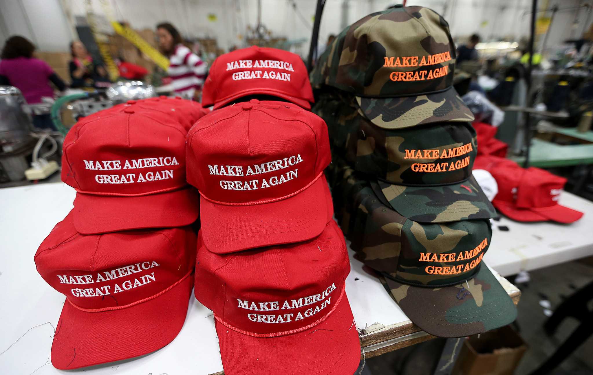A stack of newly minted Trump campaign hats sit at the end of a production line. (Luis Sinco - The Los Angeles Times) 