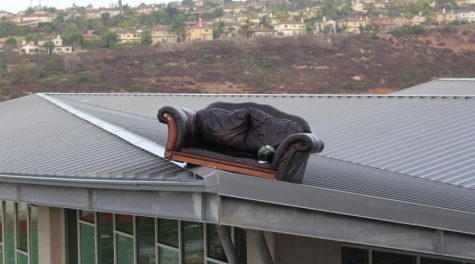 A black, leather sofa sits perched on top of the roof of the Bobcat arena.