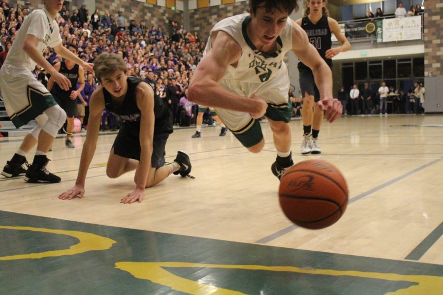 Senior forward Bryce Buscher dives for a loose ball late in the fourth quarter against CHS.