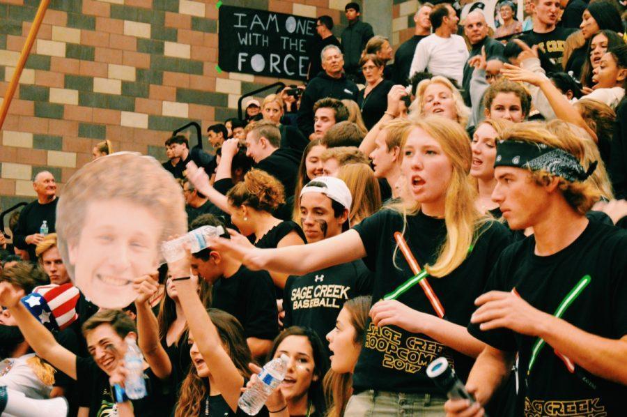 The dedicated student section rooting for Sage Creek with face paint and blown up pictures of the players on the team.