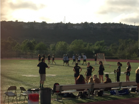 The Girls Varsity Lacrosse team watches on as play is stopped for a contact violation.
