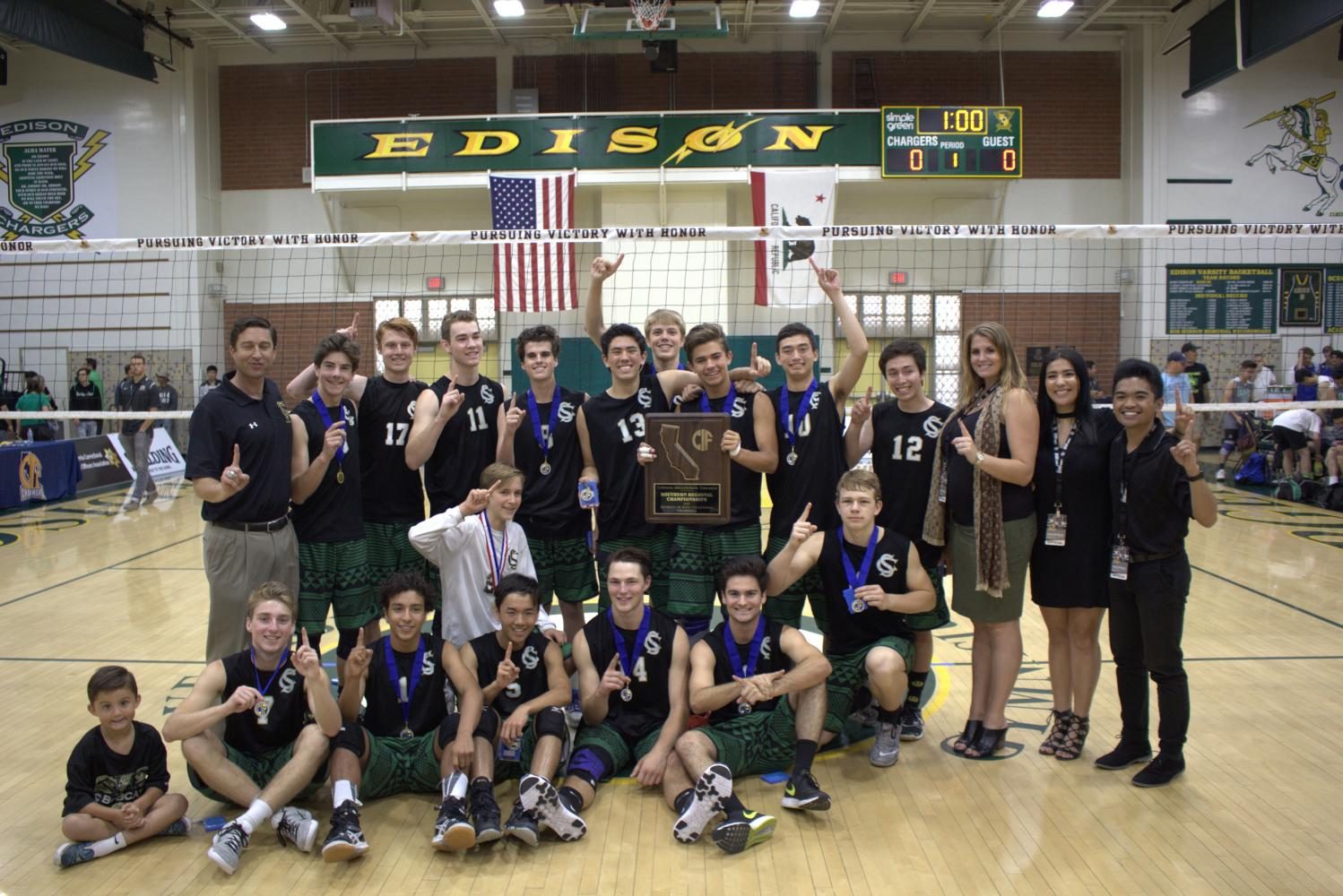 The Boys 2017 Varsity Volleyball team proudly displays their state championship trophy and medals