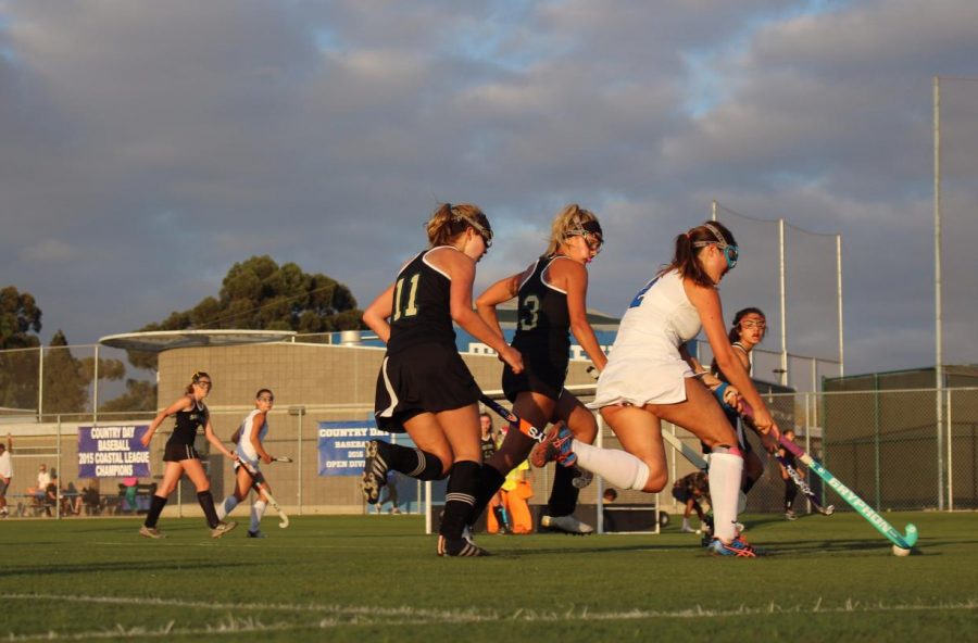 Sage Creek field hockey players defend La Jolla Country Day player.