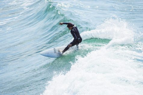 Senior David Fosman surfs the south side break of the Oceanside pier.
