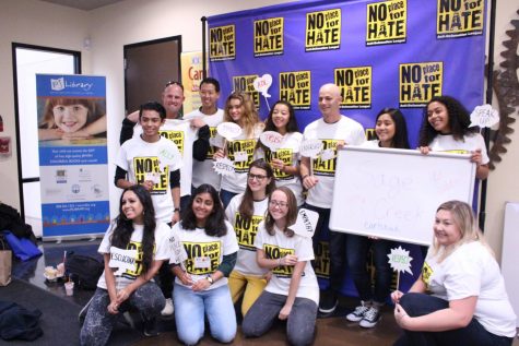 No Place for Hate team lines up for a photo in their new shirts while holding up words of kindness.