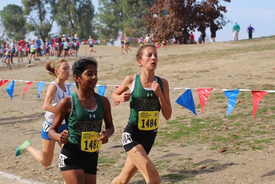 Elizabeth Gerhardt (right) races alongside teammate Lavanya Pandey (left) at the CIF State championships in Fresno, California during thanksgiving break Saturday, Nov. 25. Elizabeth finished her final race of the 2017-2018 cross country season with a bang and aided Sage Creek’s girls cross country team to place second overall. 