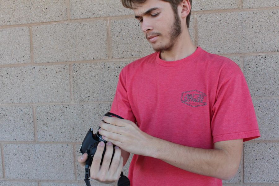 Chris Beauchamp preps the camera to get ready for the filming of a self produced film. 
