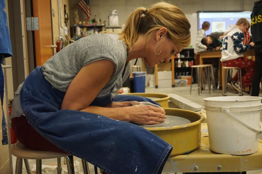 Art teacher Cathryn Burroughs models a project for her ceramics class. Burroughs has taught a variety of art classes over the span of her career. 