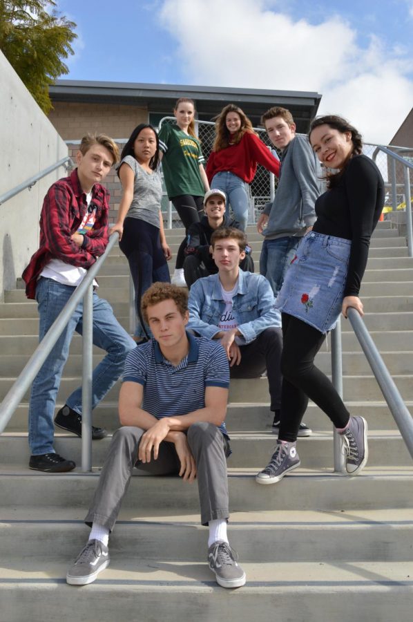 The nine senior directors of the 2018 Senior Directing Showcase pose dramatically on a staircase outside of the performing Arts Center. The directors worked on producing a scene for their project in which they had to pick, cut, cast, and direct before the showcase was performed for parents, peers, and theater lovers alike.