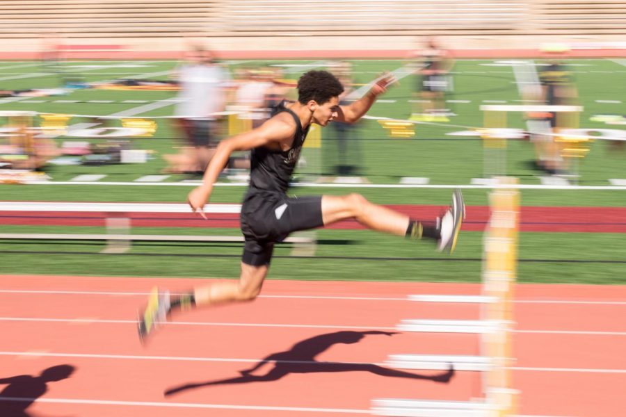 Track athlete Jordan Lee mid flight in his leap over a hurdle. Lee went on to
win first place.