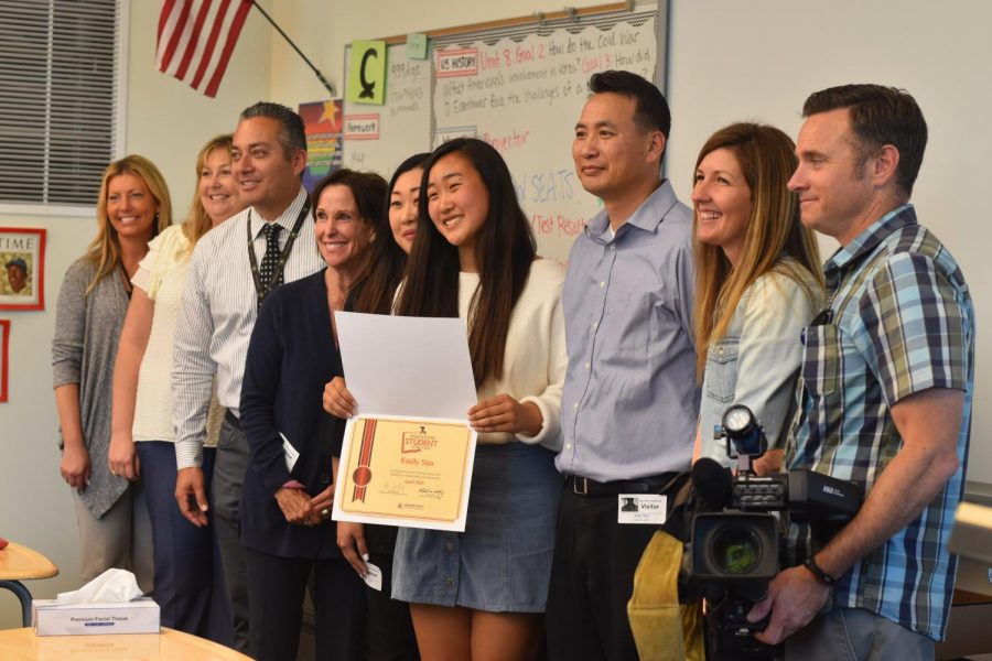 Senior Emily Sim, stands proudly with her newly accumulated certificate, next to her parents and school staff. She was interviewed on her successes with her “Senior Prom” Genius project for NBC 7 News broadcasters. 
