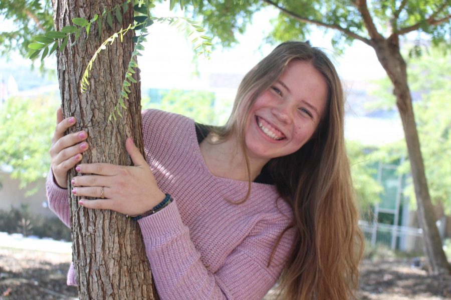 With even more happiness than before, Kailiyah Hauser demonstrates her love for nature and everything kind by posing near the Sage Creek trees while talking about her life. 
