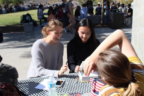 Seniors Tess Tran and Julia Hamilton utilize their lunch period to study for finals and get last minute help from their friends. This has been a common custom for Sage Creek students as they prepare to do their B.E.S.T.
