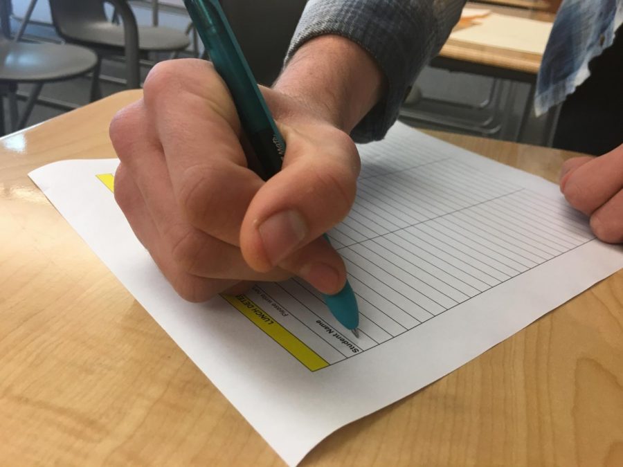 A Sage Creek student signs into lunch detention in Ms.Brown’s room. Detention has been used as the primary means of discipline in many schools across the country for decades.