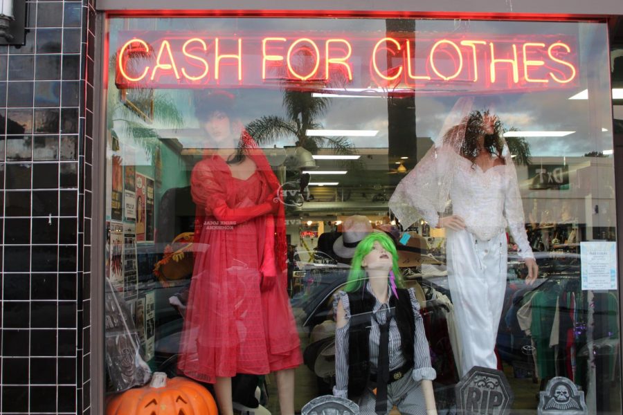 A sign titled Cash for Clothes, in the front window, promotes their policy that you can sell your old clothes for money.