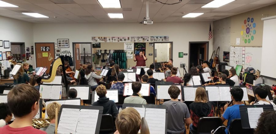 Juliana Quinones in the midst of conducting her orchestra class. They are preparing for upcoming performances.