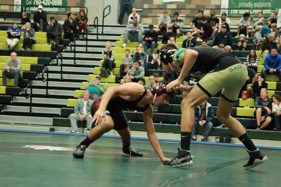 Junior Miguel Rojas prepares for his next move. Miguel wrestled in the 138 weight class for the Thursday duel.