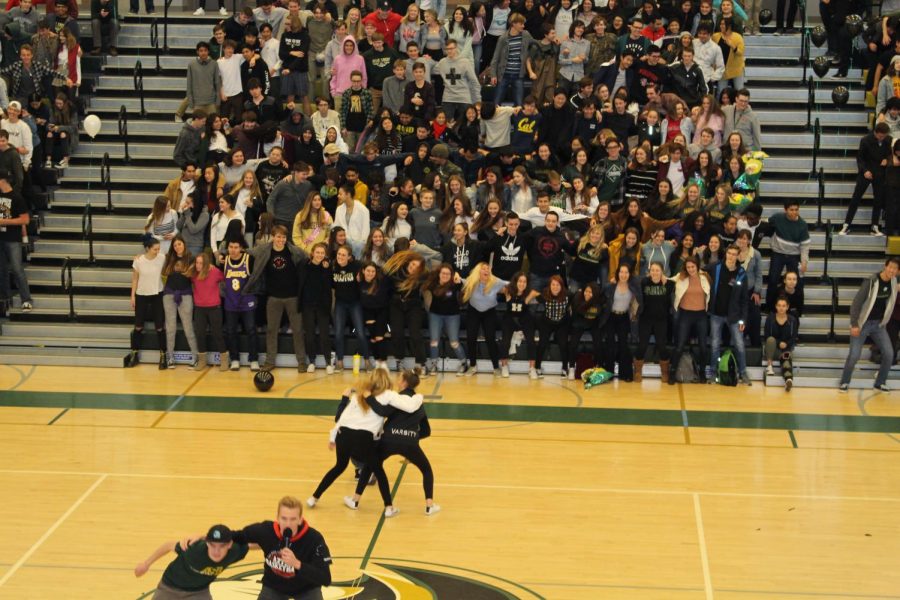 ASB members Cierra Healy and Mary Feldmann sway back and forth during last weeks pep rally, teaching the upper classman a new cheer to use at spring sports games. Last friday, the recognition rally recognized students and faculty for various departments and around campus.