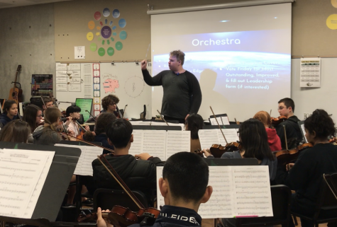 Sophomore EJ Hardy conducts during orchestra in preparation for their upcoming concert. The Spring Concert will be on Thursday, Feb. 28 in the Performing Arts Center.