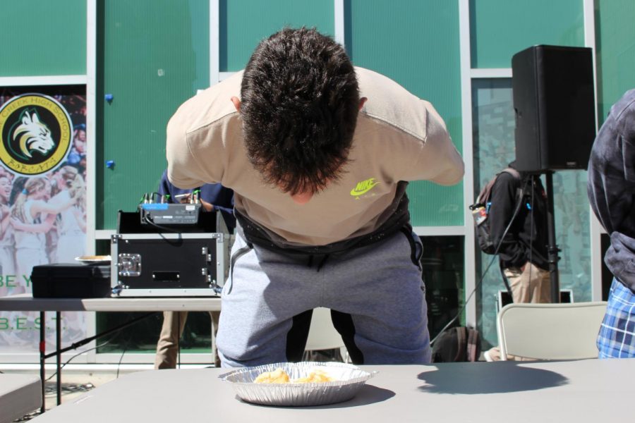 Sophomore Kasper Kasradze participates in a pie eating contest. ASB celebrated Pi day at lunch with various contests and music while students gathered to enjoy.