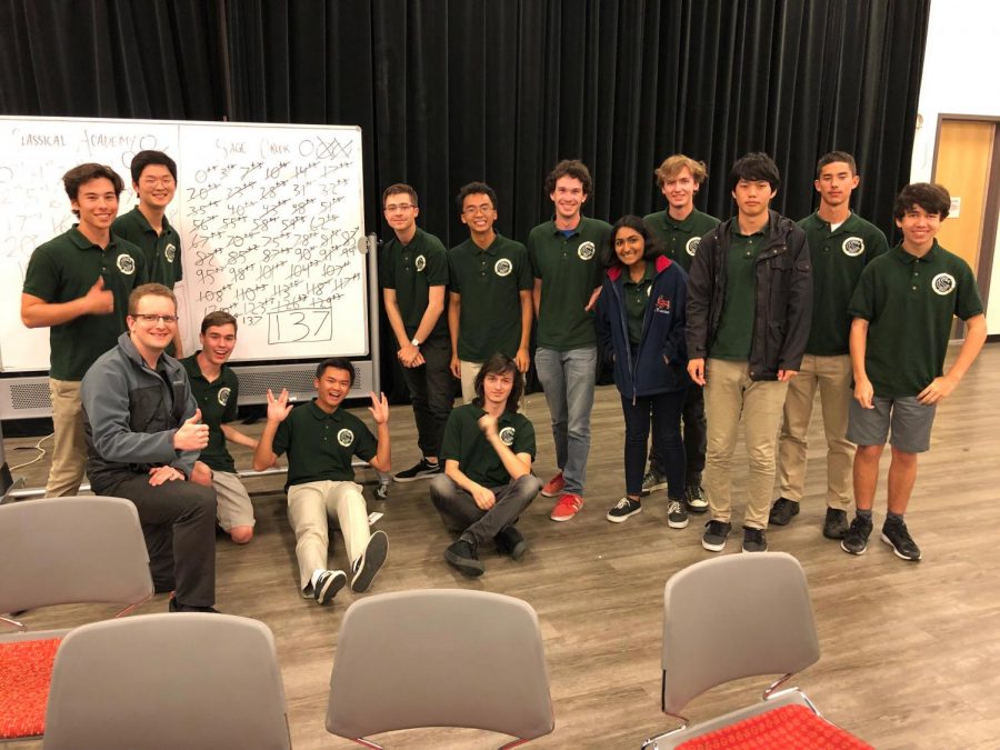 The team poses after winning their play-in match to participate in the championship tournament. The 137 score on the whiteboard not only marks the win of the match, but the highest score in the teams history.