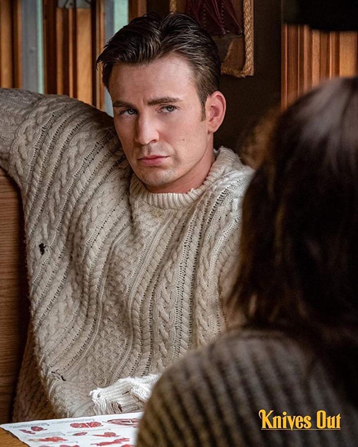 Chris Evans sports a cross-knit sweater. He plays Ransom Drysdale, nephew of Harlan Thrombey.
