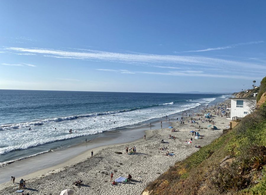 From the wooden staircase overlooking the beach, people can observe the coast’s beautiful skies, waves, and families enjoying their Saturday. With some COVID-19 restrictions being lifted the beaches continue to stay open, and the community remains socially distanced.