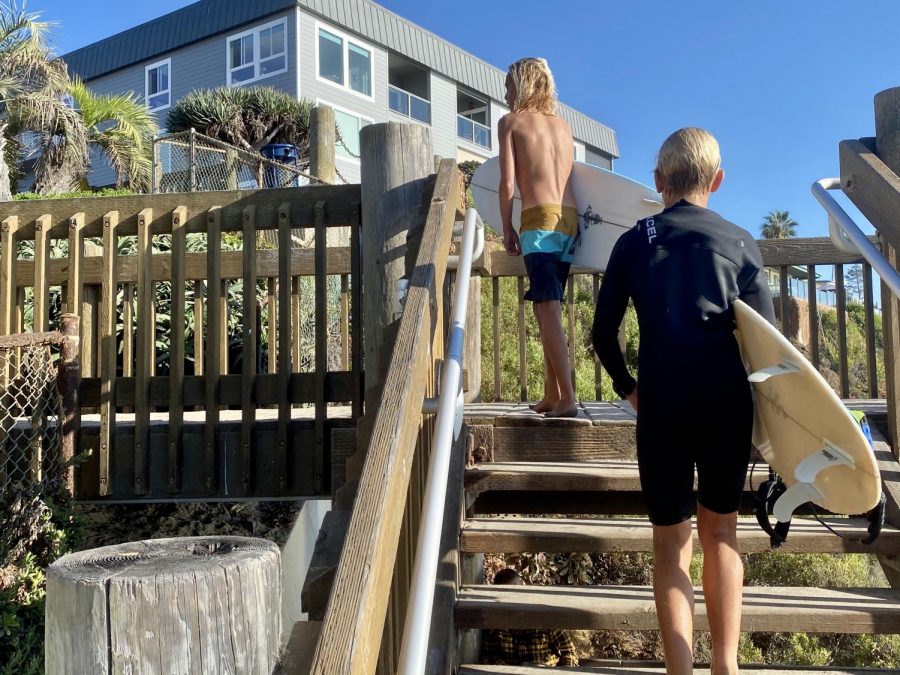 These two kids are wrapping up their afternoon surf session as they head up the stairs of Moonlight beach. Although school started back up at the end of August the weather on the coast is still great for surfing.