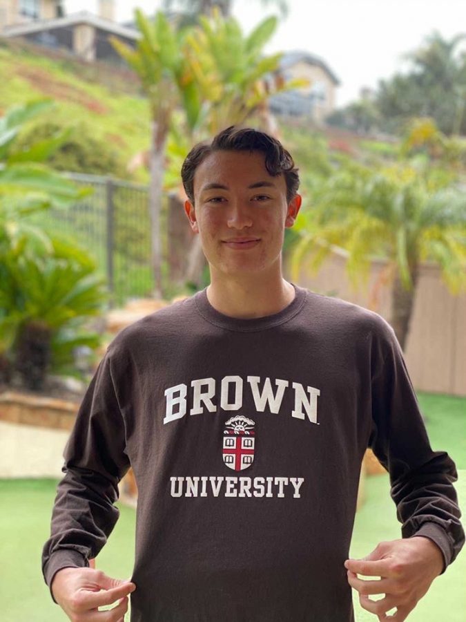 Senior Nathan Brasher poses in his backyard with his Brown University shirt after deciding to commit to the college to play baseball. He and seven other players across the country were offered a chance to play for the ivy league school. “Im committed as an outfielder for centerfield, and we also have a corner outfielder, a catcher, a short stop, and three pitchers as well,” Brasher said.