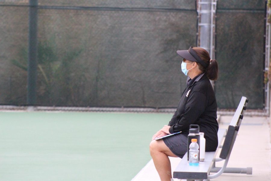Coach+Betsy+Jordan+watches+over+her+players+during+their+match+against+CCA.+The+girls+tennis+team+expressed+that+Jordan+is+extremely+supportive.+