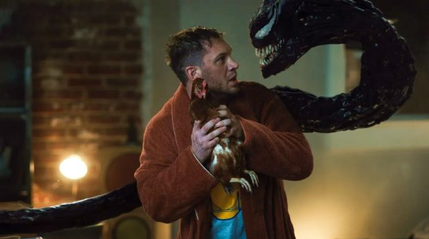 Eddie Brock holds a chicken hostage during an argument with Venom. The relationship between symbiote and host is a large aspect of this movie.