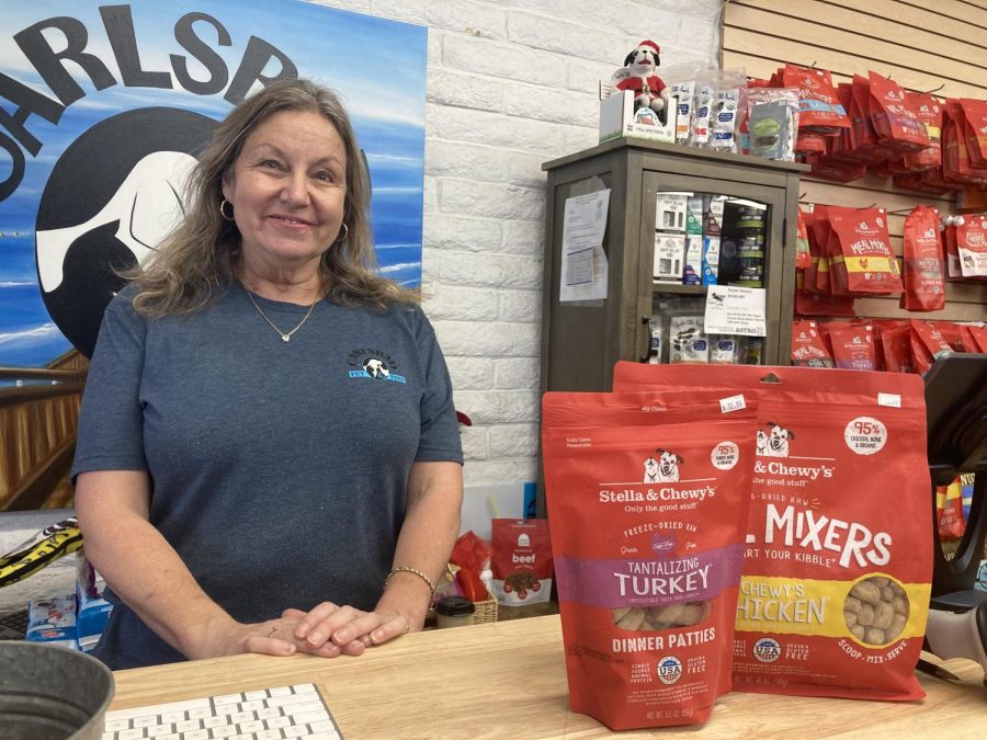 Carlsbad Pet and Feed employee Karen Bentson poses at the checkout. She finds it to be rewarding to live in a community with such amazing people. 