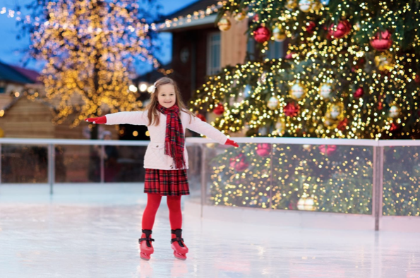 A young girl skates across the ice at an ice rink. Icetown Carlsbad not only lets citizens enjoy the holiday spirit with ice skating but also offers classes where people can learn to skate.  