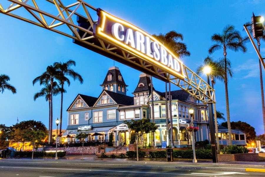 The+Carlsbad+street+sign+shines+bright+at+night.+Carlsbad+Village+is+banning+all+one-use+plastics+like%2C+straws%2C+bags%2C+utensils+and+more.+