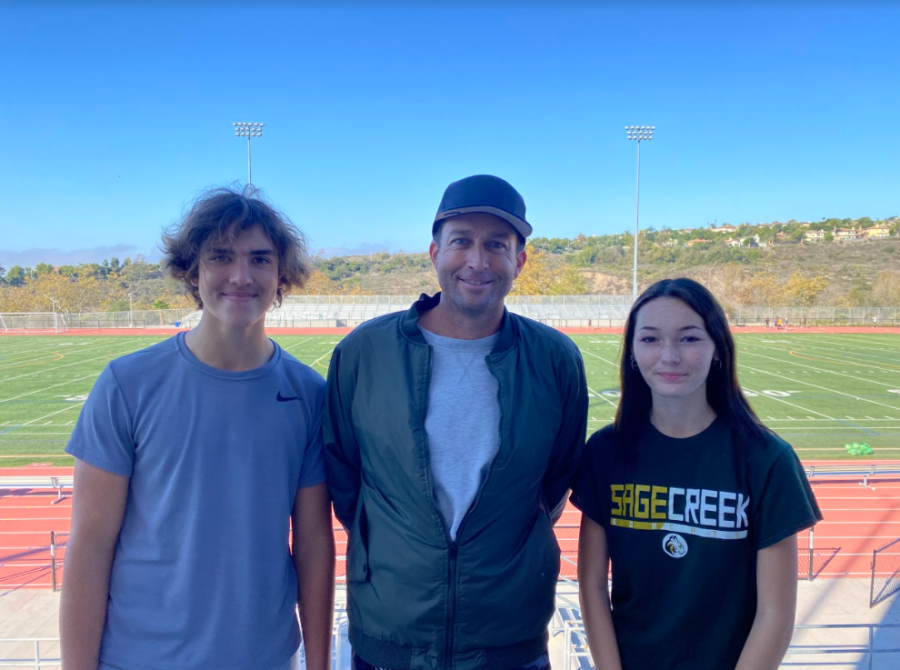 Coach Savage poses with two of his new students, Robby Nyari and Cassie Morgan. His two students have both become overall better volleyball players and expressed that they have grown more throughout his class.