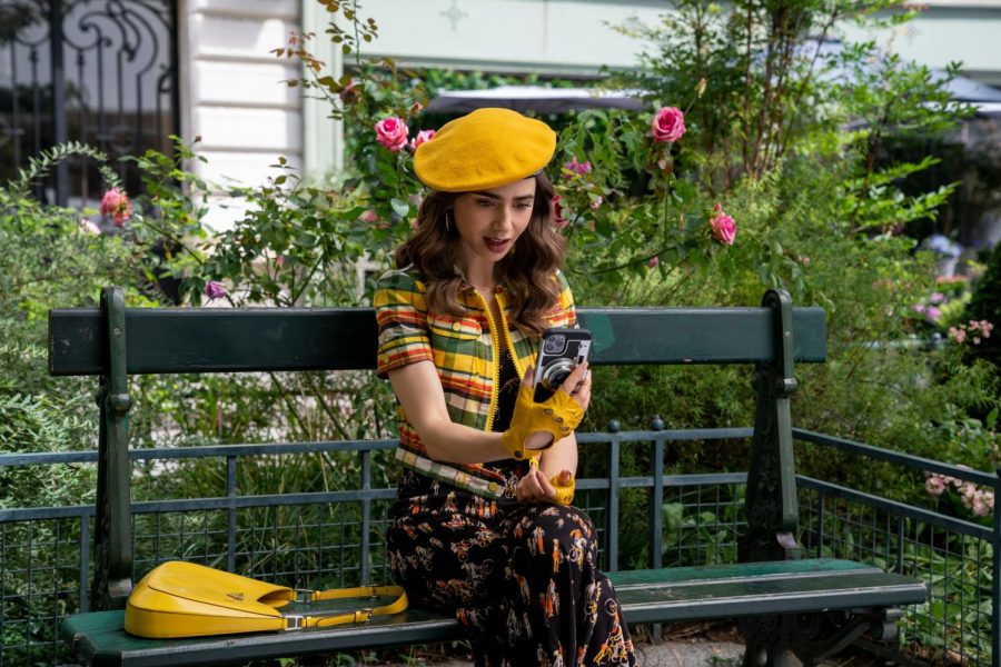 Emily taking a photo for her semi-viral “Emily in Paris” Instagram account. This is just one of her many colorful outfits, often sporting a “classic French” beret. 