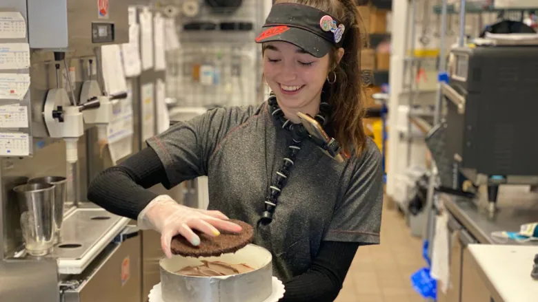A girl prepares an ice cream cake at her job. If working with ice cream looks fun or interesting to you, you should apply to Dairy Queen or Baskin Robbins!