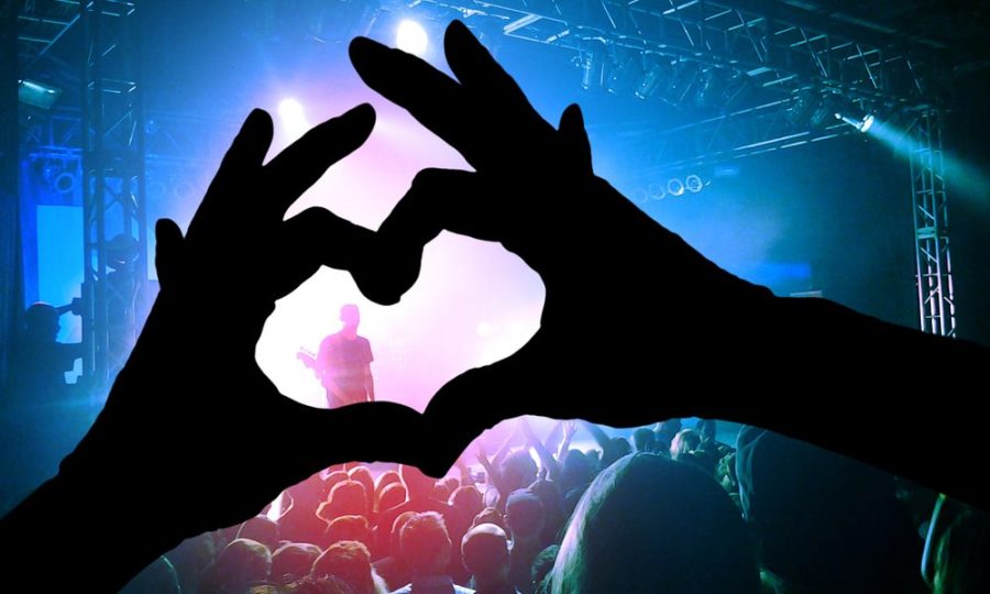 A guest makes a heart-shaped hand at a concert. The Valentine’s Super Love Jam presents attendees with an array of different bands and singers. 