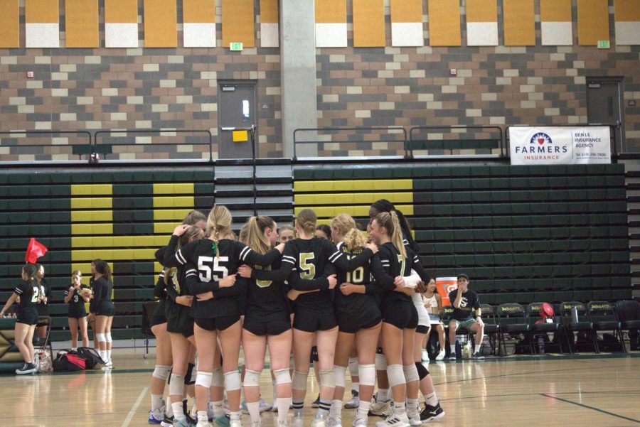 The girls volleyball team huddles up before their game. The team is 14-4 this season.