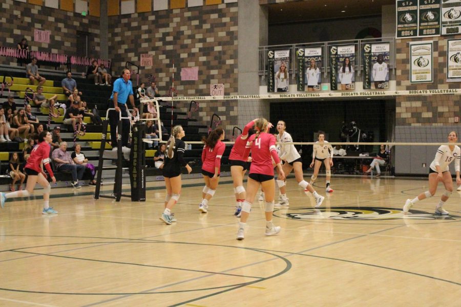 The varsity girls volleyball team prepares for an attack at their last home game. Sage Creek students supported the team by wearing pink.