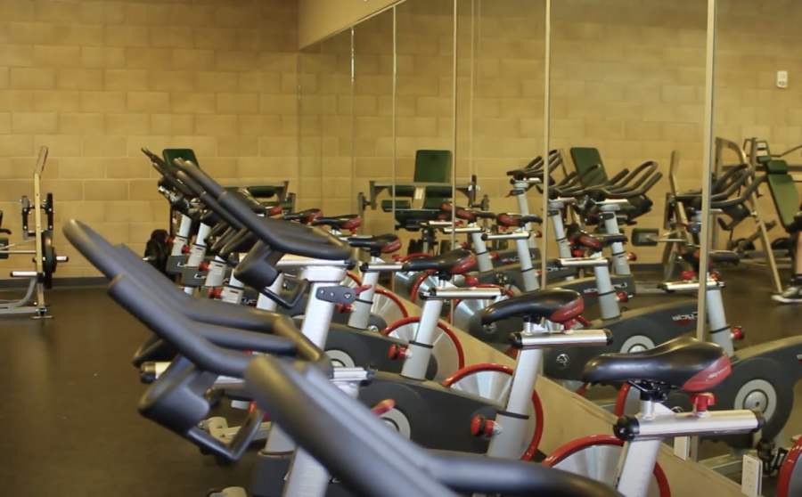 A row of exercise bikes await Strength & Conditioning students toward the entrance of the weight room. With the variety of exercise machines available, the weight room allows students to develop various parts of the body and familiarize themselves with new workouts. 