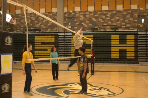 Sage Creek students play a game of lunch volleyball. Student spikes the ball to win the game. 