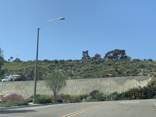 Caltrans works on the 78 freeway slopes next to the Preserve housing development and Marisol apartments. Many trucks and signs mark the road below to be cautious. 