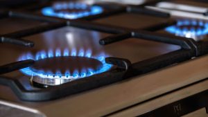 A gas stove is on, burning the fuel. Burning the gas has shown to lead to health issues, even after it’s off 
