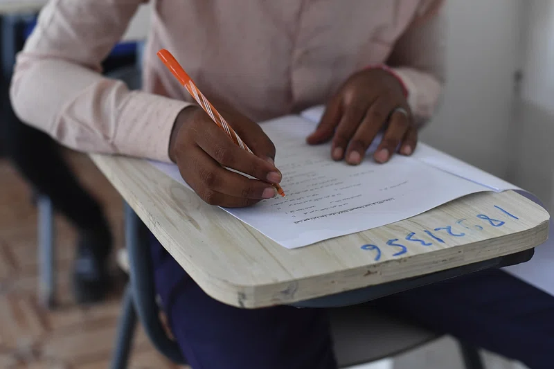 A High school student writing a college application essay during college application season. .  Exam Writing  by  United Nations Assistance Mission in Somalia
  is licensed under  CC BY 1.0 DEED