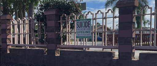 Across from the Carlsbad station, multiple signs are posted detailing the suicide prevention lifeline phone number to those at the station. This photo presents one of the lifelines, the more commonly referred to number is 988 for those in crisis.