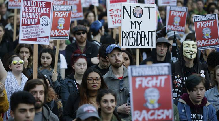 
A photo from "The Indian Express" reveals never Trumpers displaying signs as they protest the election and ideals of President-elect Donald Trump.