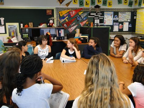 The Girls Club members gather around for their opening meeting.