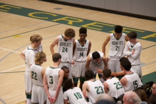 The Varsity squad gathers before the start of the fourth quarter to prepare for the tie-breaking quarter.