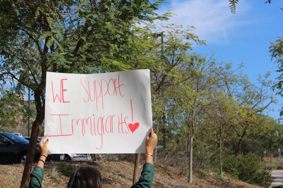 Sage Creek sophomore shows her support by leading the march back into the school holding a sign that reads “We Support Immigrants!”